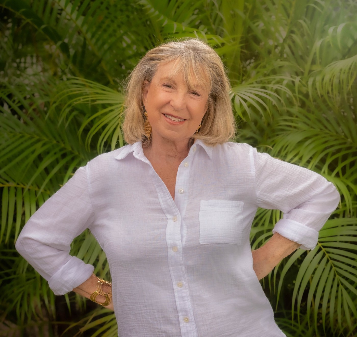 Leslie Glass smiling outdoors in a white blouse